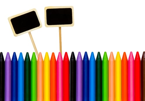 colored pencils with a little black boards isolated on white