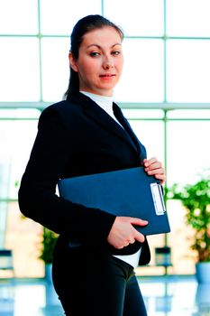 A smiling girl holding a manager office folder
