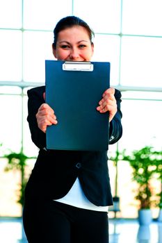 Smiling girl shows the empty office folder