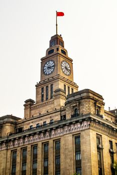 Old Customs Building with Clock and Flag, The  Bund, Shanghai, China.  The Customs Building was built in 1927.