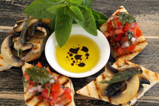 Brushetta with toppings with olive oil and balsamic vinegar.