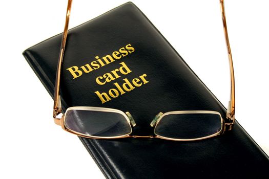 Business card holder with glasses on top.