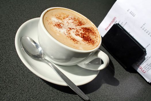 Cappuccino sitting on a table in the morning light.