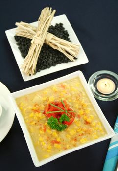 Roasted capsicum chili and corn chowder in a dark blue table setting.