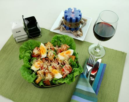 Fresh Caesar salad with lettuce, cherry tomatoes, parmesan cheese, egg, bacon and croutons.