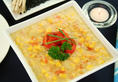 Roasted capsicum chili and corn chowder in a dark table setting.