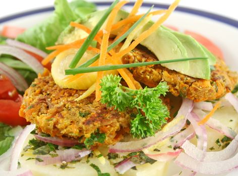 Carrot And tuna patties on a herbed potato stack with salad.