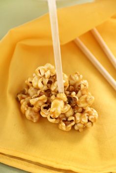 Sweet crunchy caramel popcorn on a stick ready to eat.