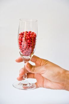 red pill in glass on white background