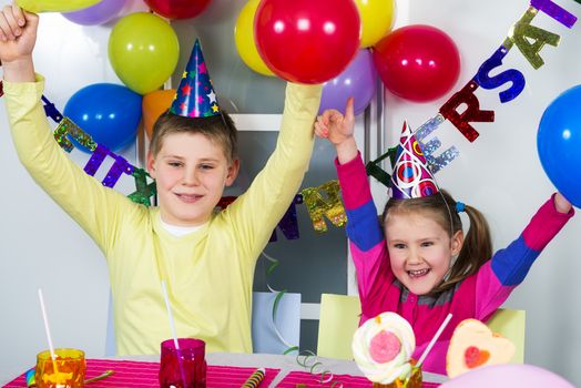 Happy little children are having fun in a birthday party 