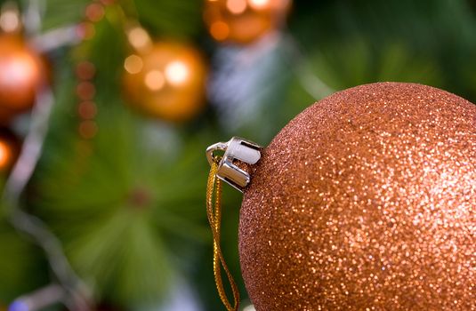 Orange Christmas toy on a background of trees