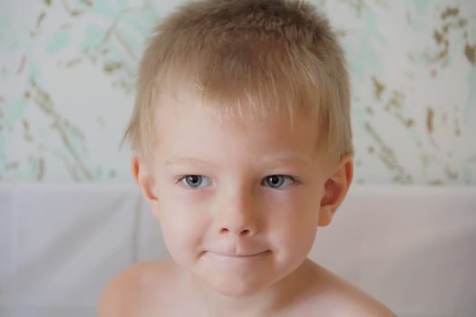 Portrait of cute boy with blue eyes