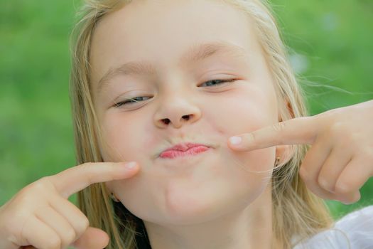 Portrait of girl with smile and makes faces
