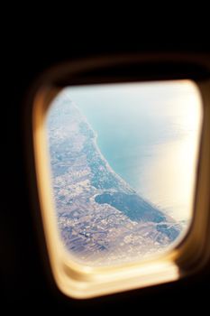 land and sea from the illuminator of airplane