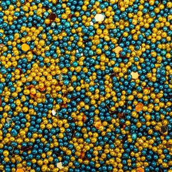 Background from Turquoise and Golden Balls of Bead, nail decoration caviar