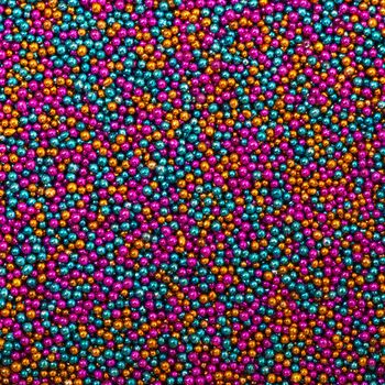 Background from Turquoise, Pink and Golden Balls of Bead, nail decoration caviar