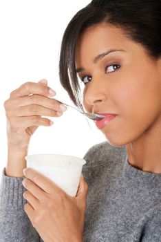 Young beautiful woman eating yogurt as healthy breakfast or snack. Isolated on white