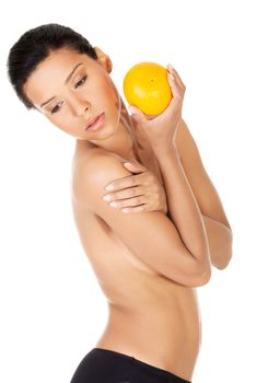 Young beautiful spa woman with orange in her hand