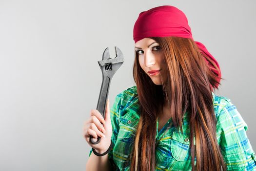 portrait of attractive girl holding adjustable wrench