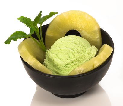 pistachio ice cream with pineapple rings and mint leaf