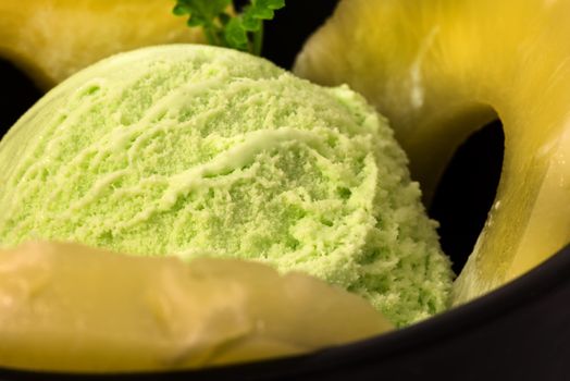 pistachio ice cream with pineapple rings and mint leaf