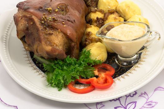 grilled knuckle of pork with potato dumplings with horseradish