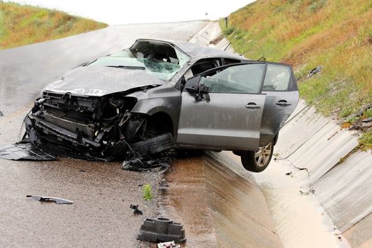 Modern automobile stuck on the road after rolling in the wet weather