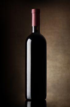 Black bottle of wine on a dark background