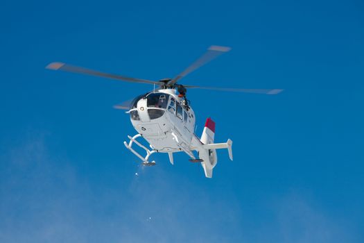 Mountain rescue helicopter against clear blue sky