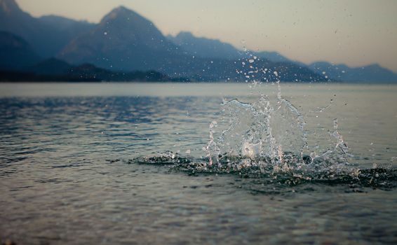Splash water on a background of mountains of Kemer.