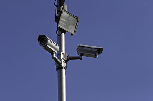 Crime control. Two security cameras monitor a parking lot.