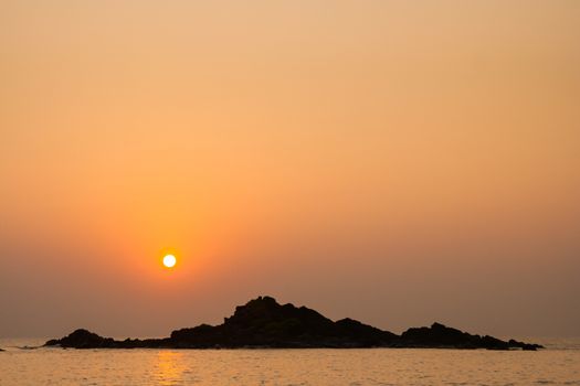 Rocky island silhouette and sunset in india