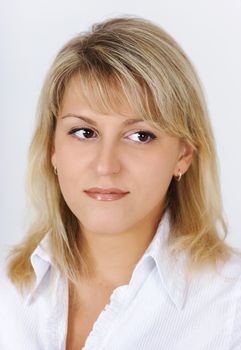 Portrait of a beautiful attractive blonde in a white blouse