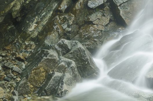 Small natural waterfall in a mountain resort shot from above