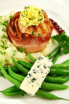 Chicken fillet mignon on parsley mashed potato with green beans and blue cheese.