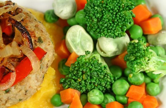 Chicken patty and fried onion with fresh steamed vegetables.