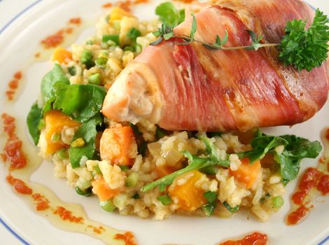 Chicken wrapped in prosciutto on pumpkin and rocket risotto.