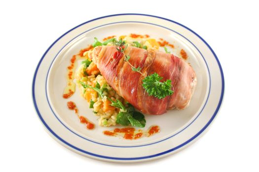 Chicken wrapped in prosciutto on pumpkin and rocket risotto.