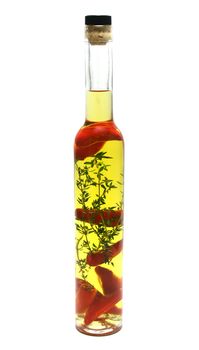 Red chillies and thyme preserved in a bottle of olive oil.