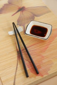 Hot and spicy chilli soy sauce with chop sticks.