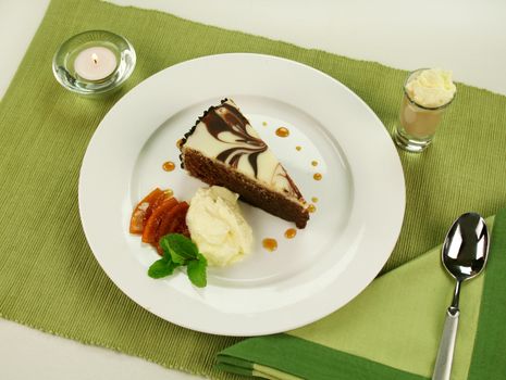 Rich chocolate cake with orange toffee and cream with a mint garnish.