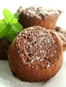 Chocolate brownies stacked up sprinkled with icing sugar.