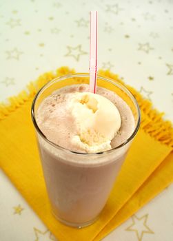 Delicious chocolate milkshake drink with spoonful of ice cream.