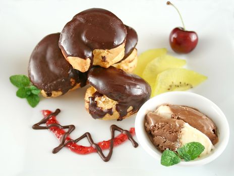 Chocolate profiteroles with kiwi fruit and ice cream.