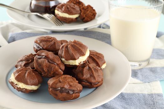 Delicious fresh baked chocolate star biscuits with chocolate sauce and a glass of milk.