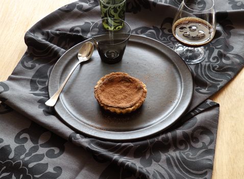 Delicious fresh baked chocolate tart with a rich black coffee.