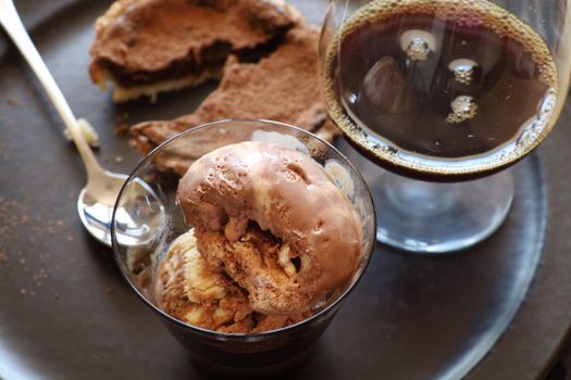 Delicious baked chocolate tart with a caramel ice cream with a black coffee liquer.