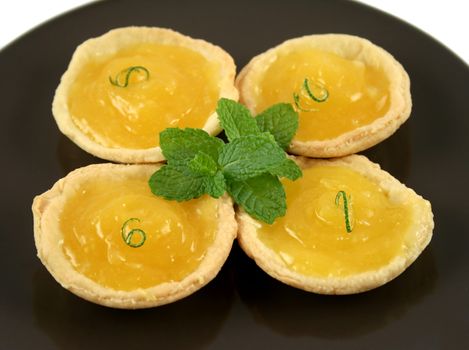 Delightful lemon tarts with a lime twist and mint.