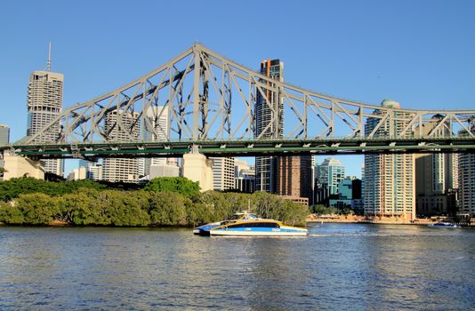 BRISBANE, AUSTRALIA - June 17 2009: City cat passes under the Story Bridge in Brisbane Queensland. The city cat ferry service began in 1996 and now has 13 vessels and is a popular tourist activity.