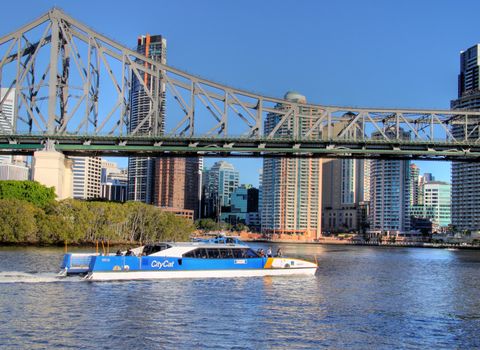 BRISBANE, AUSTRALIA - June 17 2009: City cat passes under the Story Bridge in Brisbane Queensland. The city cat ferry service began in 1996 and now has 13 vessels and is a popular tourist activity.